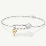 Pulsera de plata con perla y alfiler de rosa
