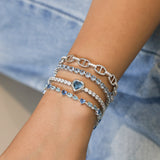 Pulsera de tenis de plata de ley con topacio de nacimiento de diciembre en corte corazón "Axis" de FANCIME