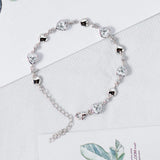 Pulsera de tenis de plata de ley FANCIME Halo Corazón con piedra de nacimiento de abril de circonita cúbica